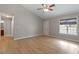 Bright living room with hardwood floors, neutral paint, and a large window offering natural light and outdoor views at 262 Tillamook Dr, Wake Forest, NC 27587