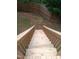 Wooden staircase from deck leads down to the backyard at 262 Tillamook Dr, Wake Forest, NC 27587