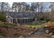 Large backyard featuring a pergola-covered patio with outdoor seating and mature trees at 2819 Meacham Rd, Chapel Hill, NC 27516