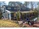 View of backyard featuring a brick patio and fire pit area with plenty of seating for entertaining at 2819 Meacham Rd, Chapel Hill, NC 27516