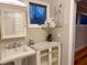 Charming bathroom featuring a pedestal sink, marble countertop, and floral accents at 2819 Meacham Rd, Chapel Hill, NC 27516