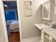 Elegant bathroom featuring a pedestal sink and view into adjacent bedroom at 2819 Meacham Rd, Chapel Hill, NC 27516
