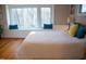 Comfortable bedroom with a large bay window, wood floors, and accent pillows at 2819 Meacham Rd, Chapel Hill, NC 27516