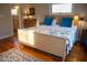 Sunlit bedroom featuring warm hardwood floors, a comfortable bed, and stylish decor at 2819 Meacham Rd, Chapel Hill, NC 27516