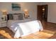 Comfortable bedroom with terracotta flooring, cozy bedding, and warm bedside lighting at 2819 Meacham Rd, Chapel Hill, NC 27516
