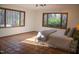 Bright bedroom features terracotta floors, large windows, and neutral decor for a serene atmosphere at 2819 Meacham Rd, Chapel Hill, NC 27516