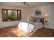 Sunlit bedroom with terracotta floors, windows showcasing a nature view, and minimalist decor at 2819 Meacham Rd, Chapel Hill, NC 27516