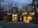 Charming home at dusk featuring a pergola-covered porch, brick pathway and a cheerful red front door at 2819 Meacham Rd, Chapel Hill, NC 27516