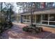 Stylish home showcasing a charming brick patio and large windows framing the interior views at 2819 Meacham Rd, Chapel Hill, NC 27516