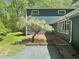 Blue house featuring a brick patio and flowering tree in a well-maintained yard at 2819 Meacham Rd, Chapel Hill, NC 27516