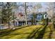 Charming two-story home with a red door, lots of light and a beautifully landscaped moss-covered yard at 2819 Meacham Rd, Chapel Hill, NC 27516