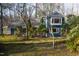 Exterior of home with large windows, mature trees and landscape at 2819 Meacham Rd, Chapel Hill, NC 27516