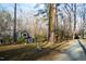 View of home exterior featuring natural landscape and gravel drive at 2819 Meacham Rd, Chapel Hill, NC 27516