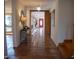 Foyer featuring terracotta floors, decorative mirror, and a glimpse of a bright red front door at 2819 Meacham Rd, Chapel Hill, NC 27516