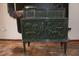 Antique wood-burning heater with detailed carvings and rustic charm, set on terracotta flooring at 2819 Meacham Rd, Chapel Hill, NC 27516