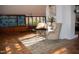 Bright sunlit living room with furniture, terra cotta tile flooring, and natural lighting at 2819 Meacham Rd, Chapel Hill, NC 27516