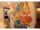 Living room featuring a vibrant floral painting, warm lighting, and terracotta floors at 2819 Meacham Rd, Chapel Hill, NC 27516