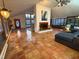 Expansive living room with bright windows, painted fireplace, and terra cotta tile flooring at 2819 Meacham Rd, Chapel Hill, NC 27516