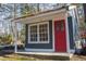 Blue outbuilding with a red door and window, surrounded by greenery at 2819 Meacham Rd, Chapel Hill, NC 27516