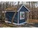 Playhouse with a colorful quilt design and a small, covered porch nestled among trees at 2819 Meacham Rd, Chapel Hill, NC 27516