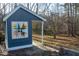 Charming playhouse featuring a colorful quilt design, covered porch and brick path at 2819 Meacham Rd, Chapel Hill, NC 27516