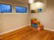 Versatile room with hardwood floors, storage steps, and a built-in nook with windows at 2819 Meacham Rd, Chapel Hill, NC 27516