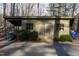 Exterior view of a shed with double doors, surrounded by shrubbery and offering practical storage at 2819 Meacham Rd, Chapel Hill, NC 27516