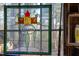 Decorative stained glass window art with a colorful, floral design enhancing the room's aesthetic at 2819 Meacham Rd, Chapel Hill, NC 27516