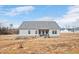 Large backyard with space for gardening and outdoor activities; covered patio enhances the living space at 295 Barbour Farm Ln, Four Oaks, NC 27524