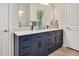 Double vanity bathroom with neutral tile and plenty of cabinet storage at 295 Barbour Farm Ln, Four Oaks, NC 27524