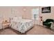 Bedroom features a bed with patterned comforter and pink decor at 295 Barbour Farm Ln, Four Oaks, NC 27524