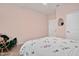 Bedroom with soft pink walls, patterned comforter and hard wood floors at 295 Barbour Farm Ln, Four Oaks, NC 27524