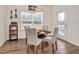 Cozy dining area with a wooden table, comfortable chairs, and natural light from a large window at 295 Barbour Farm Ln, Four Oaks, NC 27524