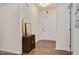 Welcoming entryway with hardwood floors, a decorative cabinet, and a view of the front door at 295 Barbour Farm Ln, Four Oaks, NC 27524