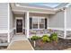 Inviting front porch with decorative door wreath and stone accents that add curb appeal to this charming home at 295 Barbour Farm Ln, Four Oaks, NC 27524