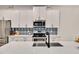Beautiful kitchen with quartz countertops, white cabinetry, stainless steel appliances, and stylish backsplash at 295 Barbour Farm Ln, Four Oaks, NC 27524