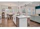 Bright kitchen featuring white cabinetry, stainless appliances, quartz counters and an island at 295 Barbour Farm Ln, Four Oaks, NC 27524