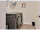 Functional laundry room with modern washer and dryer and storage at 295 Barbour Farm Ln, Four Oaks, NC 27524