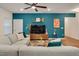 Stylish living room featuring a blue accent wall, hardwood floors, and a comfortable sectional sofa at 295 Barbour Farm Ln, Four Oaks, NC 27524