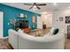 Stylish living room featuring a blue accent wall, hardwood floors, and a comfortable sectional sofa at 295 Barbour Farm Ln, Four Oaks, NC 27524