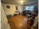 Spacious bedroom with hardwood floors, decorated with dartboard and guitar at 300 Grove St, Oxford, NC 27565