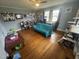 Bedroom featuring hardwood floors, a ceiling fan, and large windows for plenty of natural light at 300 Grove St, Oxford, NC 27565