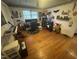 Bedroom featuring hardwood floors, a window for natural light, and decorated walls and shelves at 300 Grove St, Oxford, NC 27565