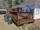 This cozy deck features wooden railings and a comfortable hanging chair for outdoor relaxation at 300 Grove St, Oxford, NC 27565