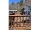 This cozy deck features wooden railings and a comfortable hanging chair for outdoor relaxation at 300 Grove St, Oxford, NC 27565
