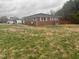 Charming brick home with blue shutters surrounded by a lush green lawn at 300 Grove St, Oxford, NC 27565