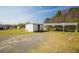 The house has a white shed, covered parking, and sits on a spacious, well-maintained lot at 300 Grove St, Oxford, NC 27565