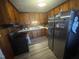 The kitchen has wood cabinets, stainless steel refrigerator, laminate counters and flooring at 300 Grove St, Oxford, NC 27565