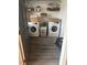 Functional laundry room featuring a washer and dryer, storage shelves, and modern flooring at 300 Grove St, Oxford, NC 27565