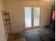 Room featuring hardwood floors with exercise equipment and access to the backyard at 300 Grove St, Oxford, NC 27565